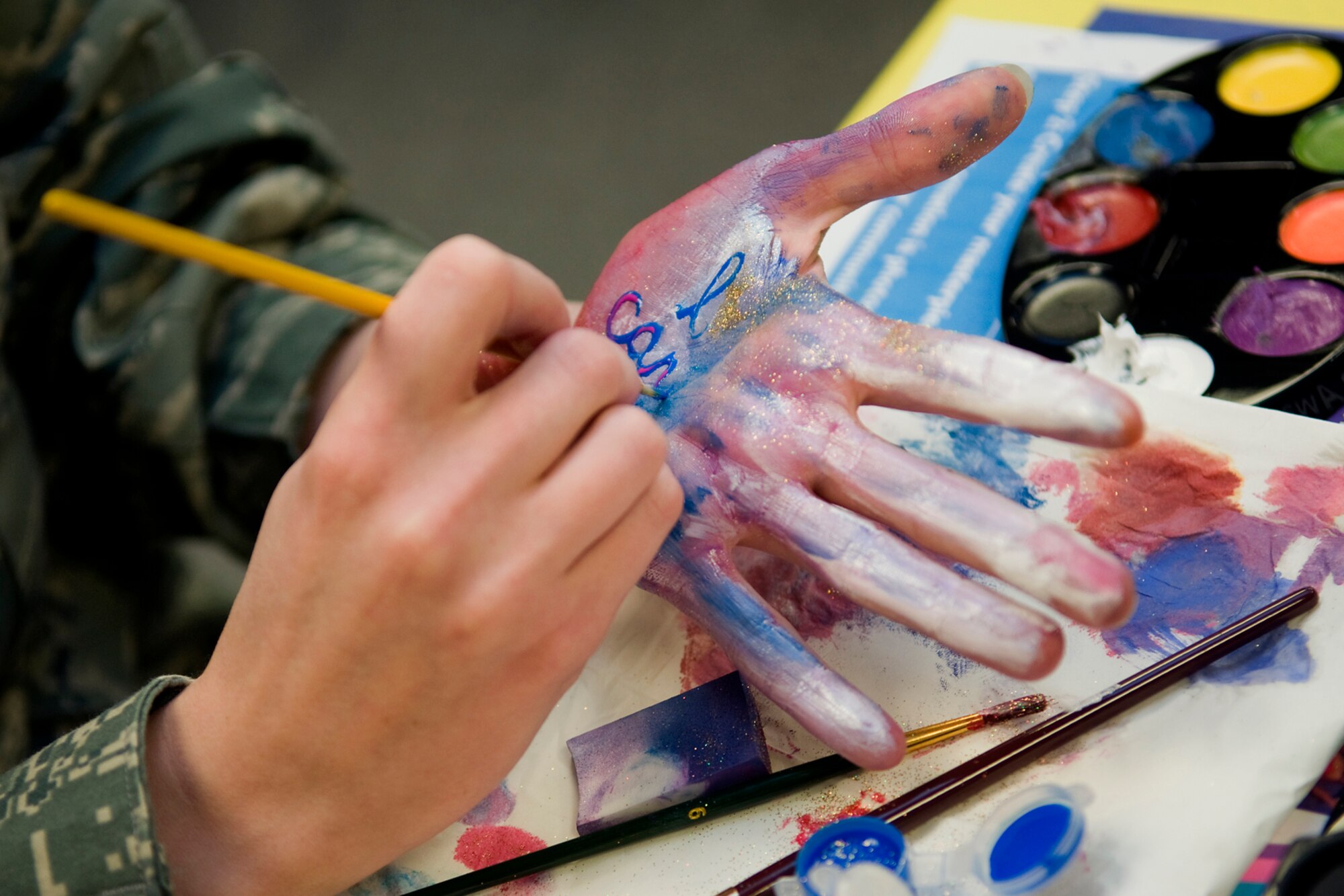 Tech. Sgt. Erica Morgan, 434th Aircraft Maintenance Squadron personnel specialist, paints her hand with an I Can statement at Grissom Air Reserve Base, Ind., Oct. 17, 2013. October is Domestic Violence Awareness Month. (U.S. Air Force photo/Tech. Sgt. Mark R. W. Orders-Woempner)
