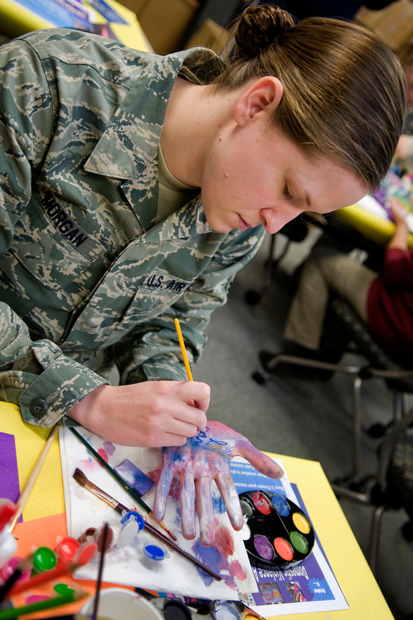Tech. Sgt. Erica Morgan, 434th Aircraft Maintenance Squadron personnel specialist, paints her hand with an I Can statement at Grissom Air Reserve Base, Ind., Oct. 17, 2013. October is Domestic Violence Awareness Month, and Grissom personnel took time to decorate their hands as a way to show their support for ending domestic violence. (U.S. Air Force photo/Tech. Sgt. Mark R. W. Orders-Woempner) 
