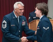 HANSCOM AIR FORCE BASE, Mass. -- Chief Master Sgt. Mitchell Balutski, Hanscom Air Force Base senior enlisted advisor, congratulates newly promoted Airman 1st Class Kara Watts during the monthly enlisted promotion ceremony at the Minuteman Commons, Oct. 31. At the monthly ceremony, generally held on the last duty day of the month, the Hanscom community recognizes enlisted Airmen selected for promotion. (U.S. Air Force photo by Mark Herlihy)
