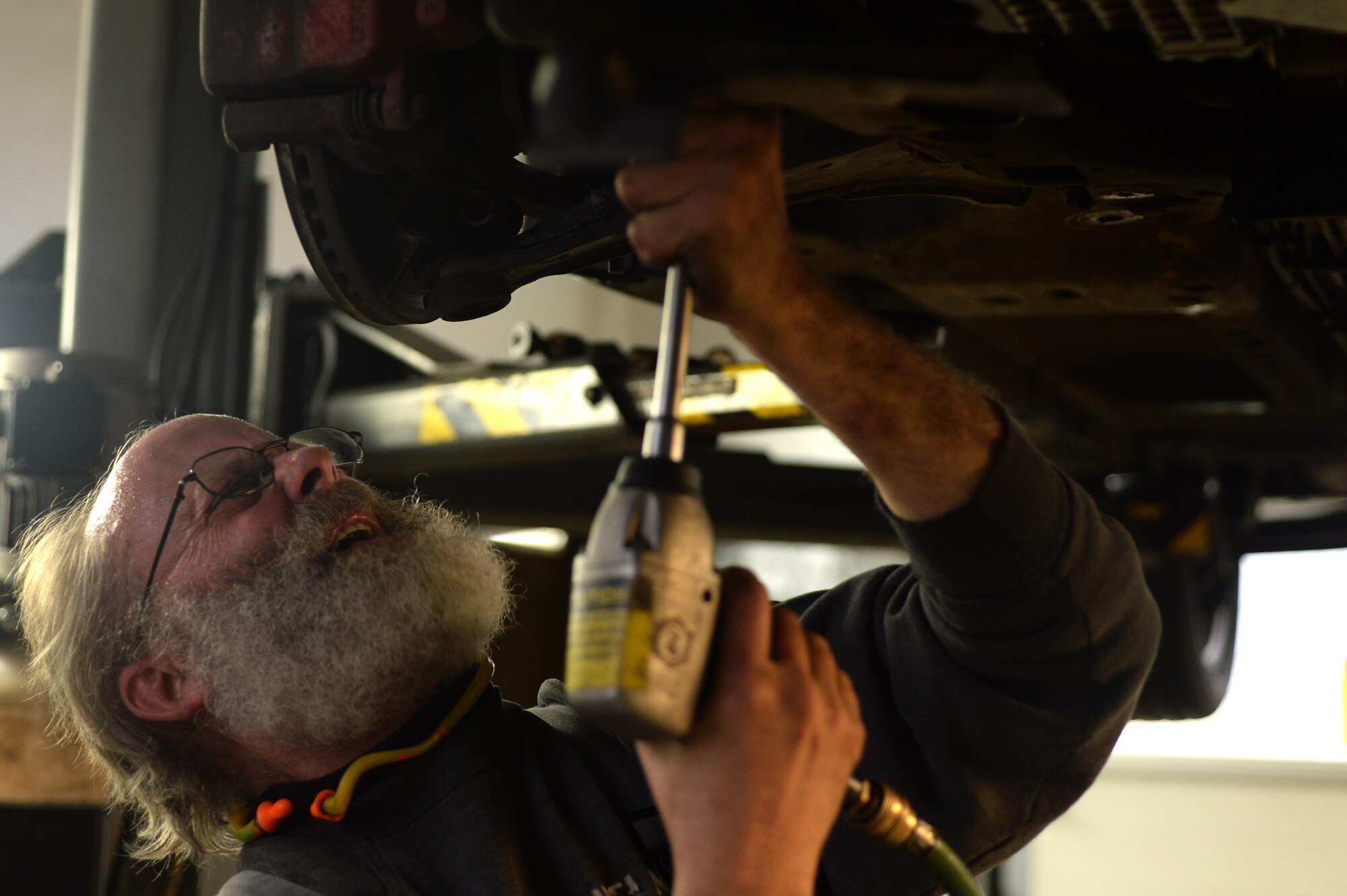 SPANGDAHLEM AIR BASE, Germany — John Forsythe, 52nd Force Support Squadron Auto Hobby Center mechanic, removes a bolt from a 2005 Dodge Neon Nov. 7, 2013. The center routinely repairs a wide variety of vehicle issues and conducts maintenance. (U.S. Air Force photo by Senior Airman Alexis Siekert/Released)