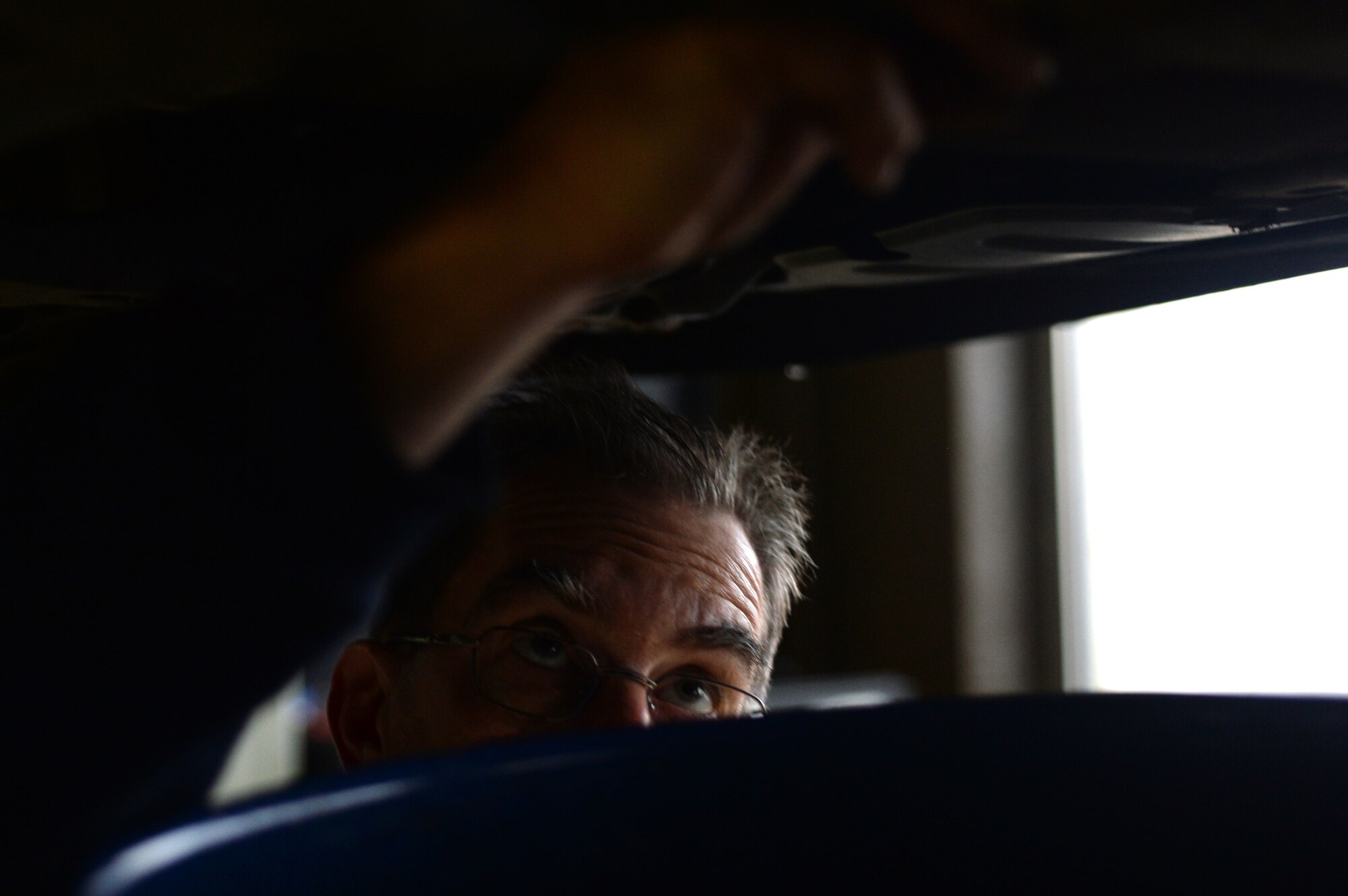 SPANGDAHLEM AIR BASE, Germany — Mike Adamoyurka, 52nd Force Support Squadron Auto Hobby Center mechanic, changes the oil of a Honda Civic Nov. 7, 2013. The Auto Hobby Center is taking scheduled appointments to prepare Spangdahlem members for winter driving. (U.S. Air Force photo by Senior Airman Alexis Siekert/Released)