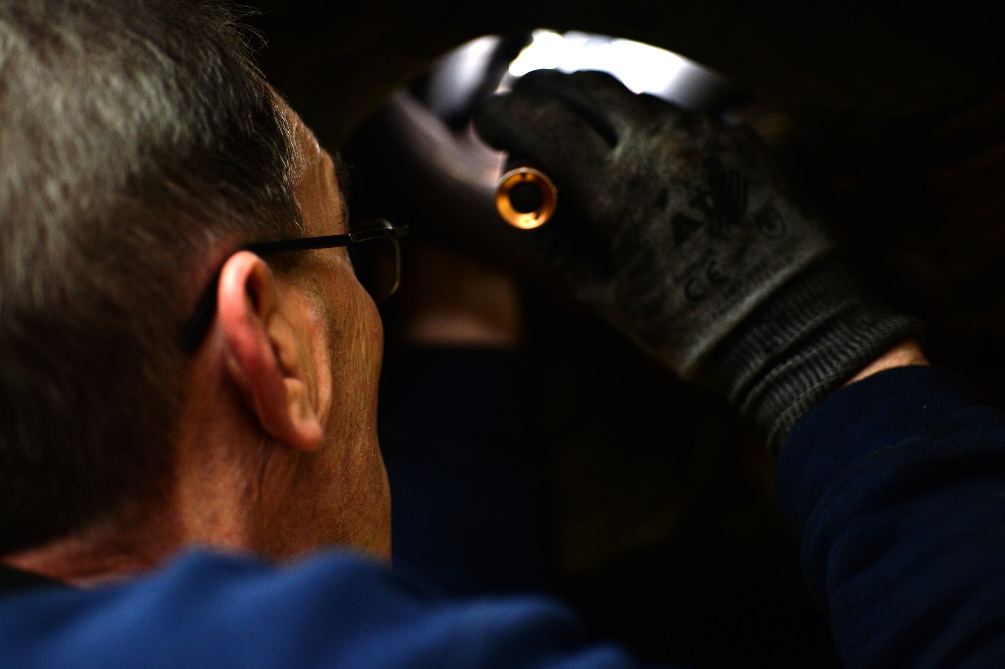 SPANGDAHLEM AIR BASE, Germany — Mike Adamoyurka, 52nd Force Support Squadron Auto Hobby Center mechanic, investigates a wiring problem on a 2003 Kia Sedona Nov. 7, 2013. The mechanics typically see six or more vehicles a day and have had a recent increase due to vehicle winterization. (U.S. Air Force photo by Senior Airman Alexis Siekert/Released)