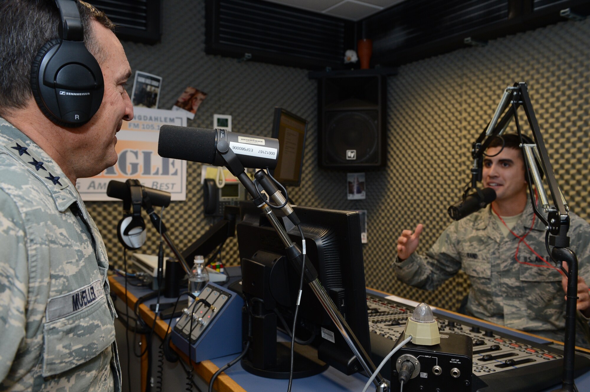 SPANGDAHLEM AIR BASE, Germany – Lt. Gen Stephen Mueller, U.S. Air Force inspector general, talks on the radio with Airman 1st Class Jared Rand, American Forces Network-Spangdahlem radio host, at AFN Nov. 5, 2013. When Mueller was the 52nd Fighter Wing commander, he would end his radio shows with the song “Brick House” by The Commodores. (U.S. Air Force photo by Airman 1st Class Kyle Gese/Released)