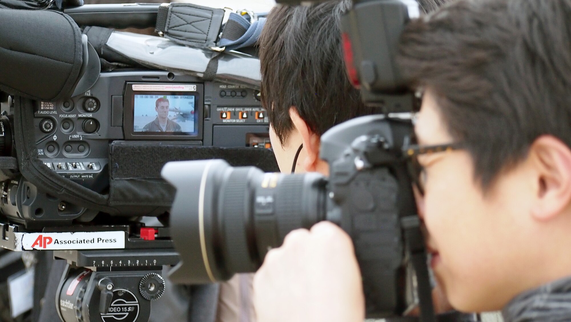 KUNSAN AIR BASE, Republic of Korea – Local and international journalists film and photograph an interview with 1st Lt. Billy Baker, 80th Fighter Squadron F-16 pilot, during the Exercise Max Thunder media day on Kunsan Air Base, Republic of Korea, Nov. 6. More than 20 local, national and international reporters and photographers came to Kunsan AB to see the exercise, which fosters bilateral aerial training between the Korea Air Power Team including the U.S. Air Force, Army and Marine Corps and the Republic of Korea Air Force. (U.S. Air Force photo by Tech. Sgt. Thomas J. Doscher)