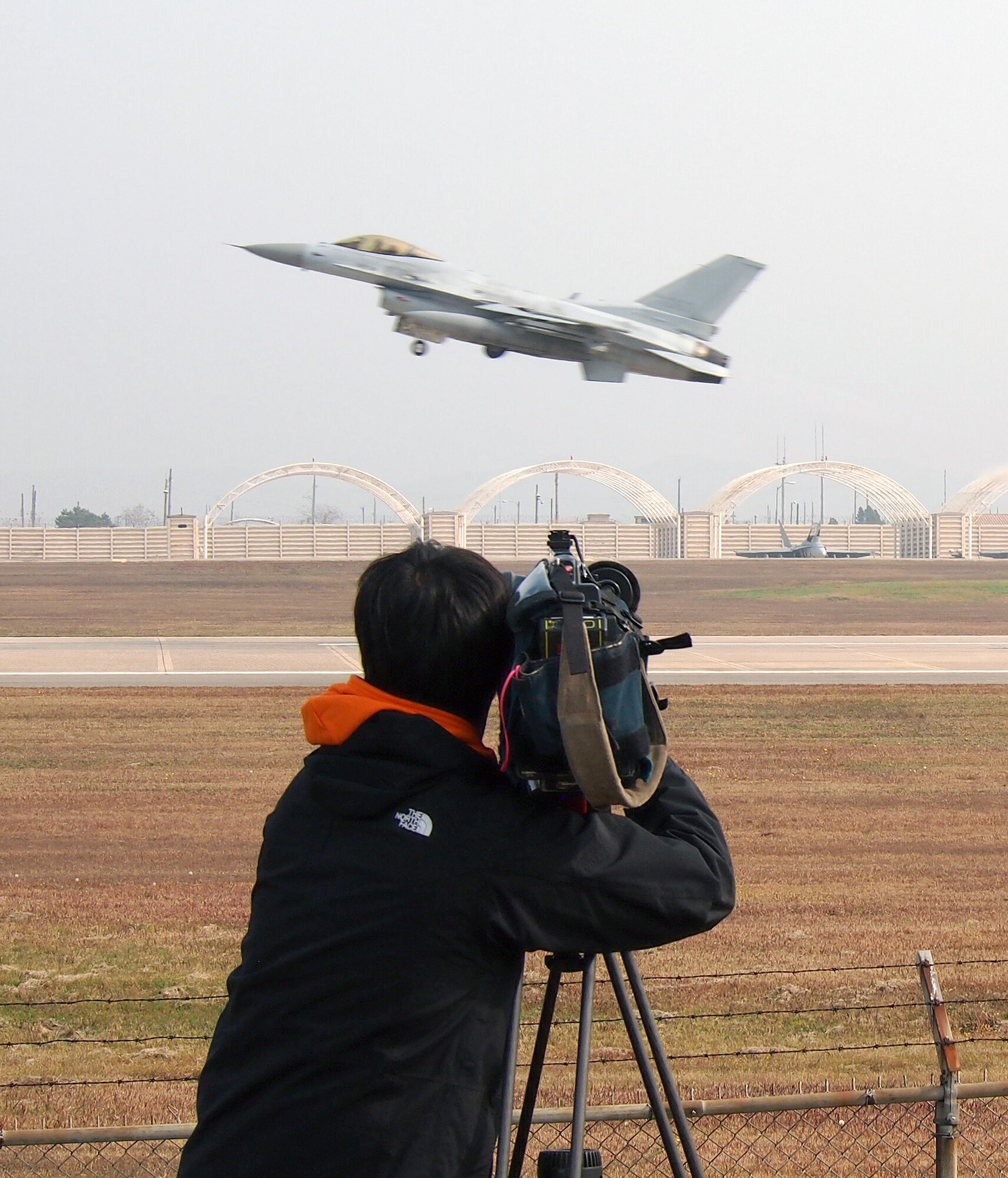 KUNSAN AIR BASE, Republic of Korea – A videographer films a Republic of Korea Air Force KF-16 taking off to participate in Exercise Max Thunder during the exercise media day Nov. 6. Max Thunder replicates scenarios and planning cycles in a robust exercise setting that simulates combined operations against a hostile force. (U.S. Air Force photo by Tech. Sgt. Thomas J. Doscher)