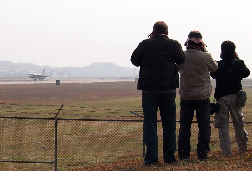 KUNSAN AIR BASE, Republic of Korea – Reporters photograph the take-off of a Republic of Korea Air Force KF-16 during the Exercise Max Thunder Media Day on Kunsan Air Base, Republic of Korea, Nov. 6. More than 20 local, national and international reporters and photographers came to Kunsan AB to see the exercise, which fosters bilateral aerial training between the Korea Air Power Team including the U.S. Air Force, Army and Marine Corps and the Republic of Korea Air Force. (U.S. Air Force photo by Tech. Sgt. Thomas J. Doscher)