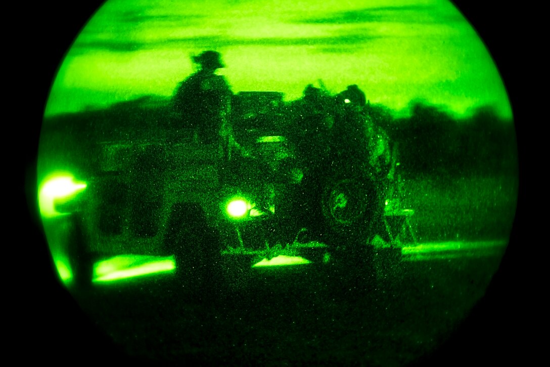 As seen through a night-vision device, Army Special Forces members drive a Humvee during a training exercise on Eglin Range, Fla., Nov. 5, 2013.