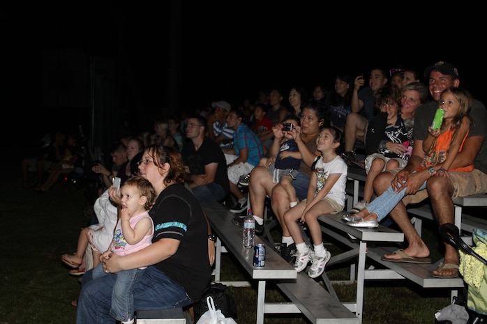 Station residents watch the night sky light up with hundreds of fireworks at Penny Lake here Tuesday in celebration of Independence Day. The fireworks display had been postponed due to inclement weather.