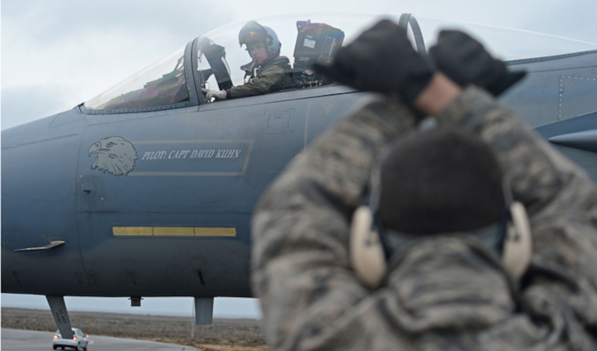 Senior Airman Kyle Eisler marshals an F-15C Strike Eagle piloted by Lt. Col. Mark Sadler, Nov. 4, 2013 at Keflavik International Airport, Iceland. Airmen from Royal Air Force Lakenheath and RAF Mildenhall, England; Spangdahlem Air Base and Ramstein AB, Germany, Davis-Monthan Air Force Base, Ariz.; Tinker AFB, Okla.; and Robins AFB, Ga., arrived at Keflavik International Airport to complete an air surveillance exercise in support of a bilateral agreement between the U.S. and Iceland and to conduct air surveillance and policing missions. Eisler is a 493rd Expeditionary Fighter Squadron crew chief and Sadler is the 493rd EFS commander.