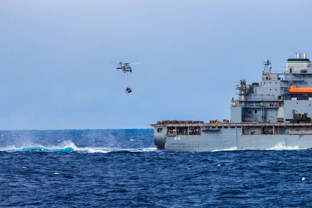 A U.S. Navy MH-60S Sea Hawk helicopter with Helicopter Sea Combat Squadron (HSC) 22 air lifts supplies from the USNS Robert E. Peary (T-AKE 5) dry cargo/ammunition ship to the USS Bataan (LHD 5) during a replenishment at sea off the East Coast Nov. 6, 2013. The 22nd MEU is currently taking part in the Amphibious Ready Group (ARG)/MEU Exercise in preparation for its scheduled 2014 deployment to the U.S. 5th and 6th Fleet areas of responsibility with the Bataan ARG as a sea-based, expeditionary crisis response force capable of conducting amphibious missions across the full range of military operations. (U.S. Marine Corps photo by Sgt. Austin Hazard/Released)