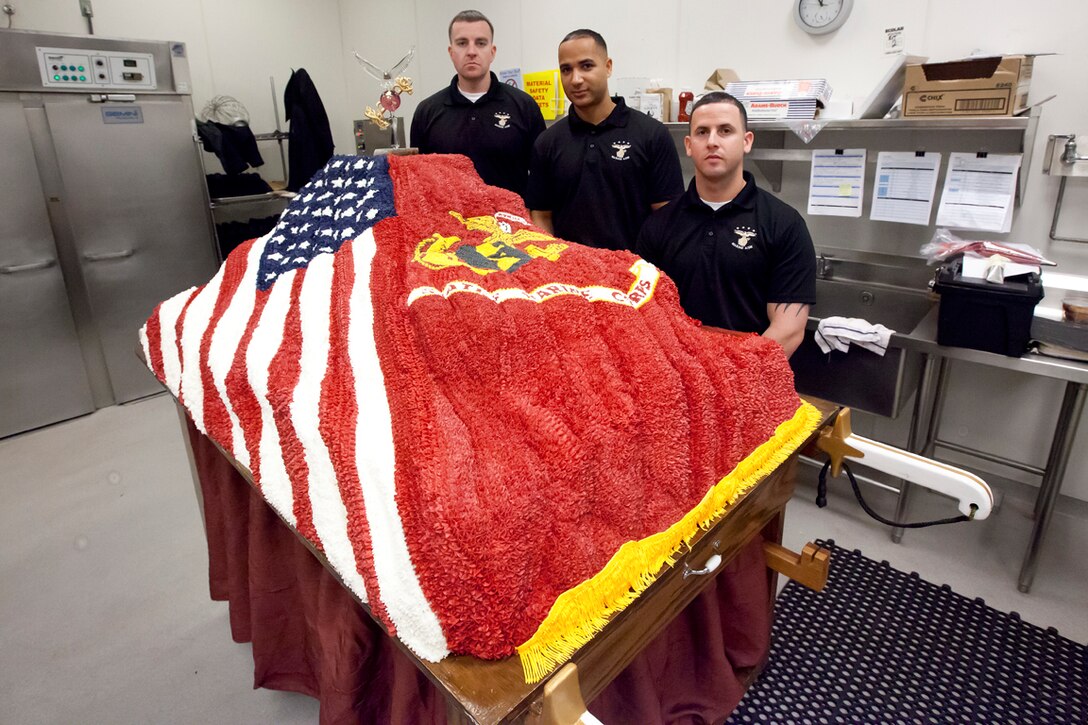 Gunnery Sgt. Charles Hughes, Marine Aide to the Commandant of the Marine Corps; Staff Sgt. Wilson Jumelles, Marine Aide at Marine Barracks Washington D.C.; and Sgt. Pedro Marrerocruz, Marine Aide to the Commandant of the Marine Corps, pose with the birthday cake they made for the Commandant's Ball, Nov. 8, 2013 at the Gaylord National Resort and Convention Center in National Harbor, Md. The cake, made from scratch in honor of the Corps' 238th birthday, weighs more than 500 lbs. and took a week to construct. Marines around the globe are celebrating the 238th birthday of the Corps with cake cutting ceremonies and birthday balls. 