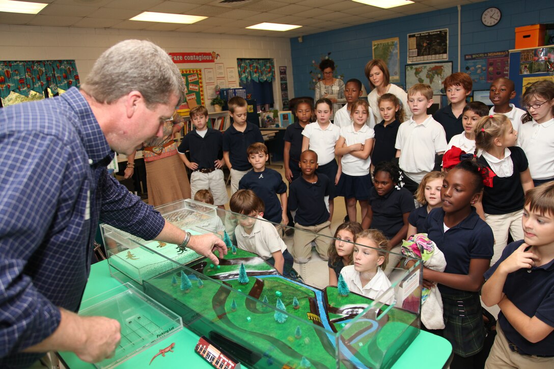 Regulatory Specialist Brian Moore uses an interactive floodplain model to demonstrate how wetlands absorb storm water and filter drinking water to a class of third grade students at Marshpoint Elementary School, Nov.5, 2013. 