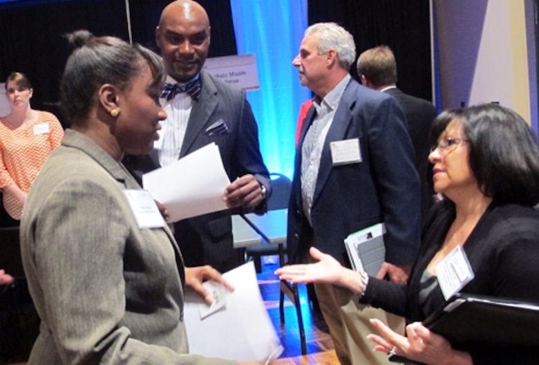 Nicole Boone, small business specialist in Huntsville Center's Small Business Office, talks with business owners during a breakout session of the Center's 2013 Small Business Forum. Boone gave a briefing on Sources Sought Notices during the information session.