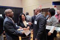 Lisa Harris, program manager, Huntsville Center’s Installation Support and Programs Management Directorate, speaks with Jesse Nunn, president at Future Research Corporation of Huntsville, during the networking session at the 2013 Huntsville Center Small business Forum held Thursday.