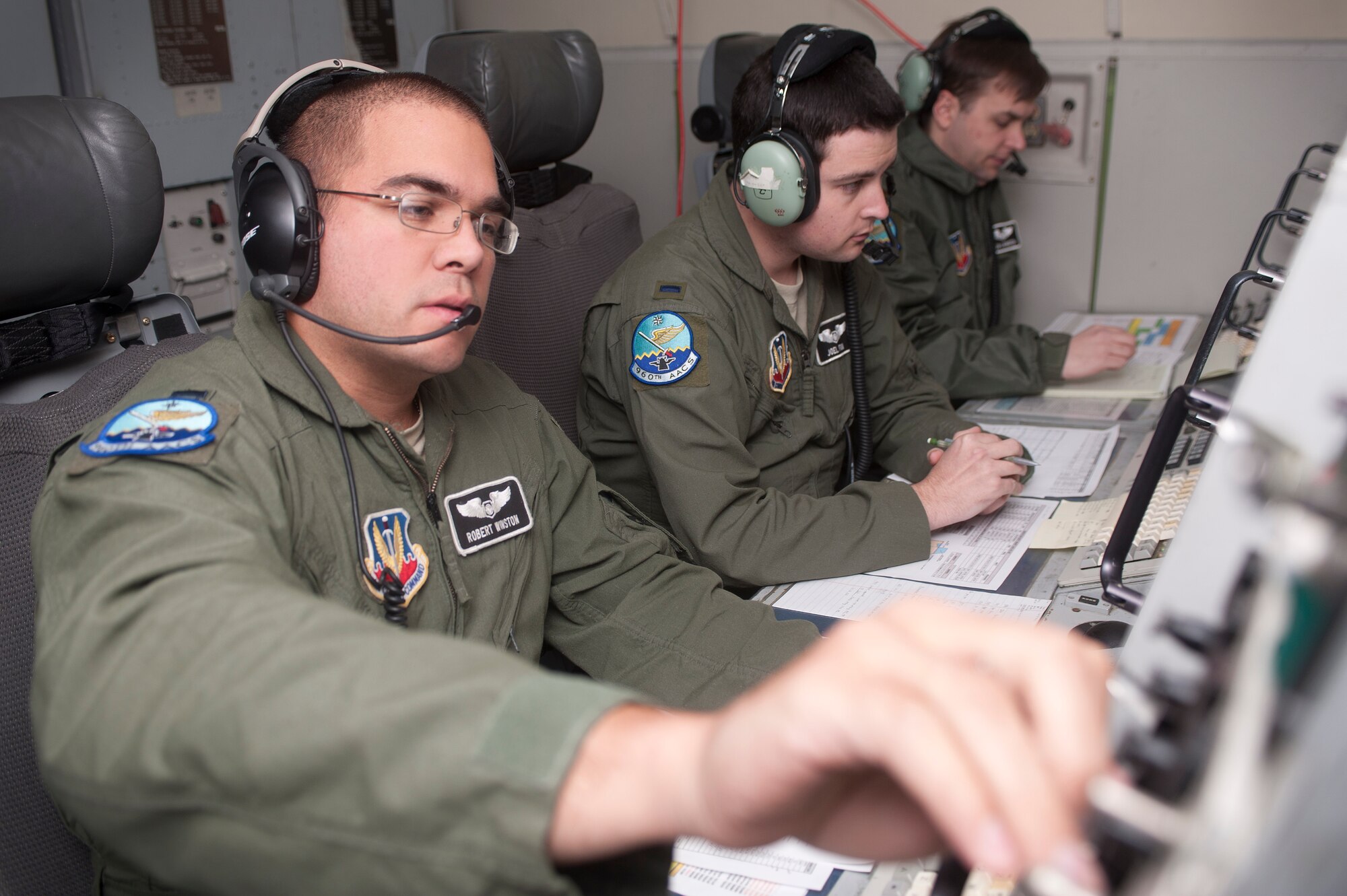 Capt. Robert Winston, 960th Airborne Air Control Squadron air weapons officer, participates in a Green Flag-West exercise on an E-3 Sentry airborne early warning and control aircraft Nov. 5, 2013, in support of ground training at Fort Irwin, Calif. Green Flag-West is a Close Air Support and Joint exercise administered by the U.S. Air Warfare Center and Nellis AFB through the 549th Combat Training Squadron. (U.S. Air Force photo by Staff Sgt. Christopher Hubenthal)