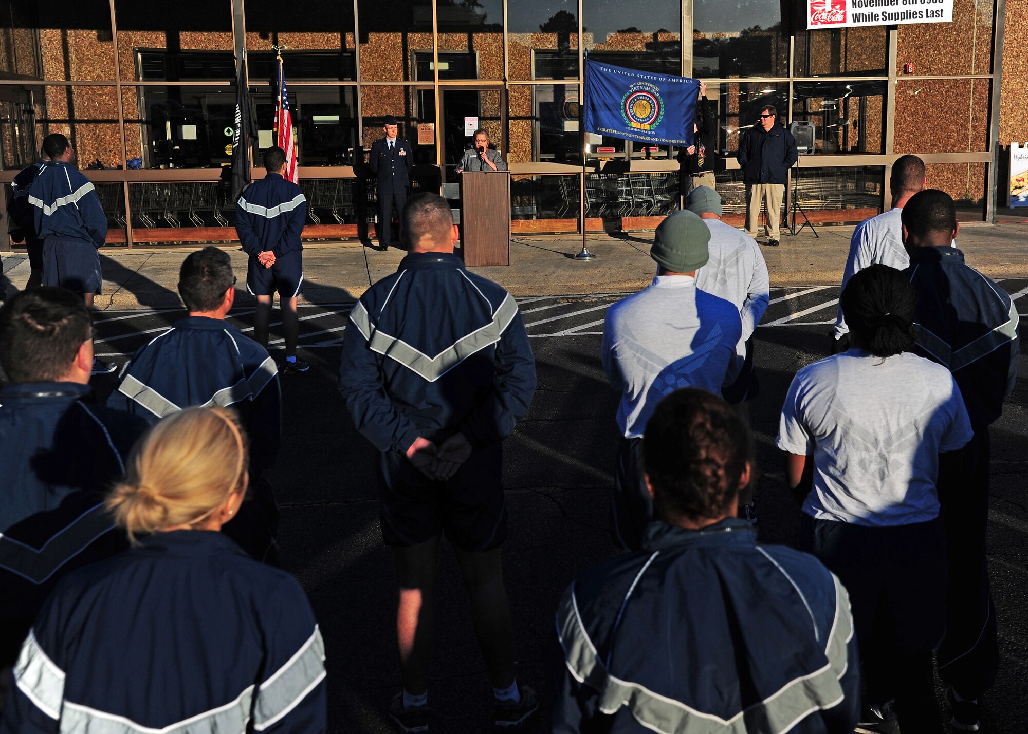 La Vida Nethercutt, Store Director of the Columbus AFB Commissary unveils a flag during the 50th during the 50th Anniverssary Vietnam War Commemoration ceremony held Nov. 8 in front of the Columbus AFB Commissary. Immediately following the ceremony the flag was taken on a 5k run in honor of the 50th anniversary of the Vietnam War.  (U.S. Air Force Photo/Airman 1st Class Stephanie Englar)