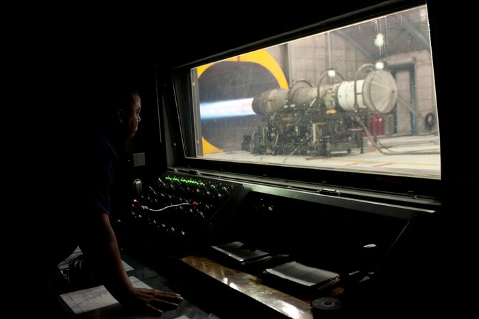 Eric Haddock, 57th Maintenance Group Propulsion Shop, contractor aerospace propulsion mechanic, observes a running engine at the Hush House Nov. 7, 2013, at Nellis Air Force Base, Nev. The test cell is a functional test to ensure engines function correctly after being maintained. The 57th MXG Propulsion Shop is responsible for the maintenance of 185 aircraft engines. (U.S. Air Force photo by Staff Sgt. Christopher Hubenthal)