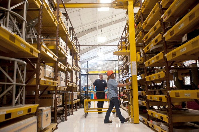 Michelinda Lapuz, 57th Maintenance Group Propulsion Shop, contractor tools and parts attendant, prepares a Heavy Tooling Stack System to transfer an engine fixture, as Bill Rice, 57th MXG Propulsion Flight aerospace propulsion mechanic, observes Nov. 7, 2013, at Nellis Air Force Base, Nev. Lapuz is responsible for more than 3,000 tools and 22 large tool kits. The 57th MXG Propulsion Shop is responsible for the maintenance of 185 aircraft engines. (U.S. Air Force photo by Staff Sgt. Christopher Hubenthal)