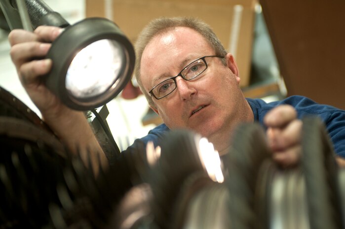Robert Marshall, 57th Maintenance Group Propulsion Shop, contactor aerospace propulsion mechanic, inspects an F100-229 engine for damage Nov. 7, 2013, at Nellis Air Force Base, Nev. The 57th MXG maintains, disassembles, assembles, inspects, repairs and tests 185 aircraft engines. (U.S. Air Force photo by Staff Sgt. Christopher Hubenthal)