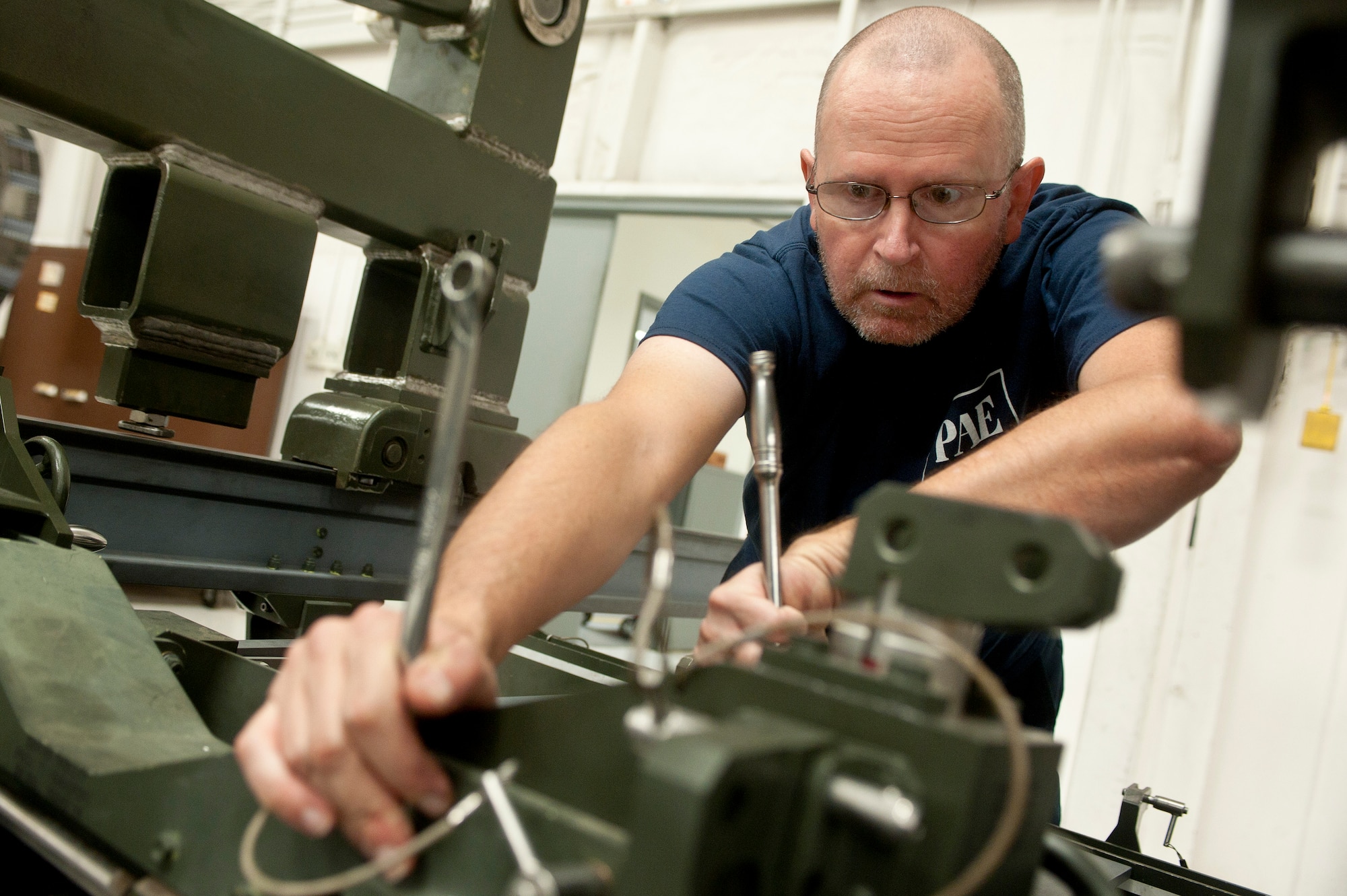 Michael Halasz, 57th Maintenance Group Propulsion Shop, contractor aerospace propulsion mechanic, conducts a two year inspection for a  Lockheed Martin F-22 Raptor engine trailer Nov. 7, 2013, at Nellis Air Force Base, Nev. The inspection identifies corrosion, cracks and worn out parts to be fixed and ensures the trailer is functional. The 57th MXG Propulsion Shop is responsible for the maintenance of 185 aircraft engines. (U.S. Air Force photo by Staff Sgt. Christopher Hubenthal)