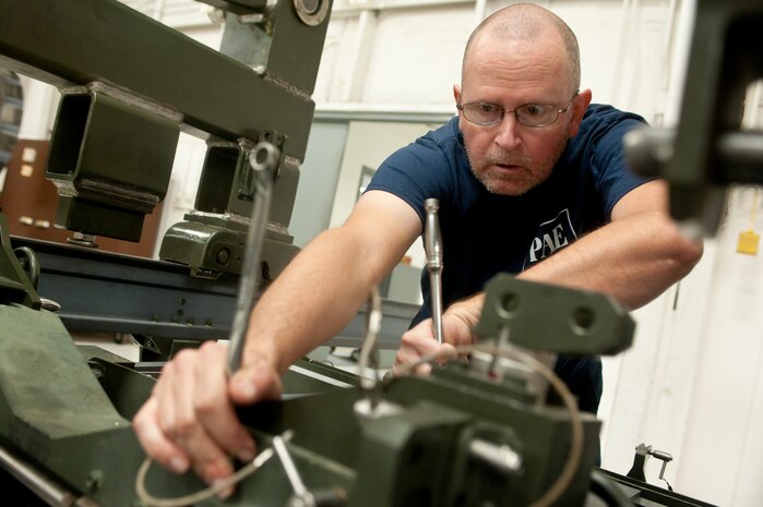 Michael Halasz, 57th Maintenance Group Propulsion Shop, contractor aerospace propulsion mechanic, conducts a two year inspection for a  Lockheed Martin F-22 Raptor engine trailer Nov. 7, 2013, at Nellis Air Force Base, Nev. The inspection identifies corrosion, cracks and worn out parts to be fixed and ensures the trailer is functional. The 57th MXG Propulsion Shop is responsible for the maintenance of 185 aircraft engines. (U.S. Air Force photo by Staff Sgt. Christopher Hubenthal)