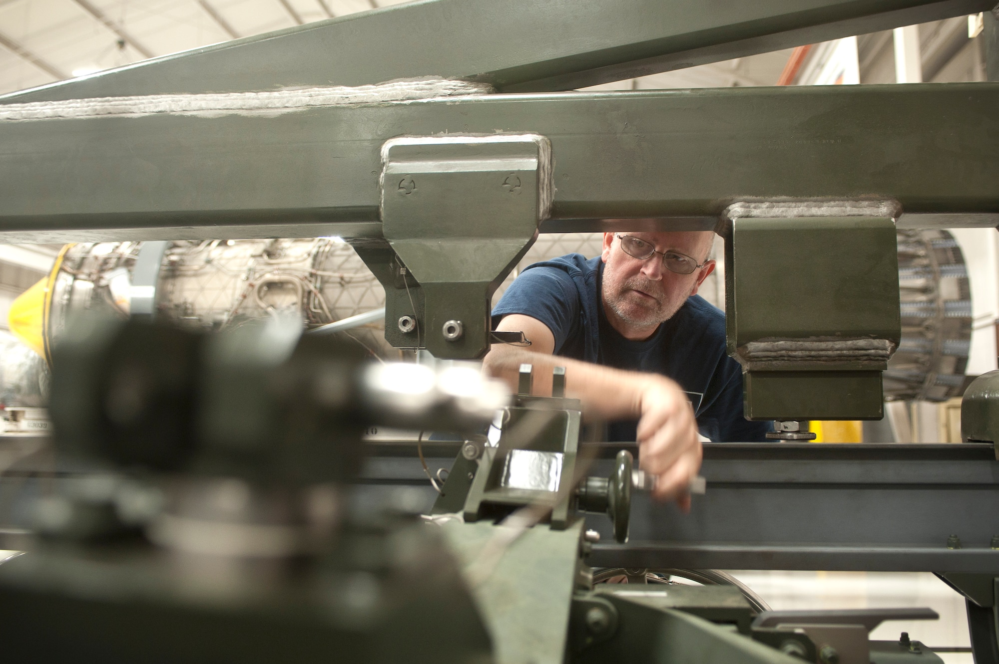 Michael Halasz, 57th Maintenance Group Propulsion Shop, contractor aerospace propulsion mechanic, conducts a two year inspection for a  Lockheed Martin F-22 Raptor engine trailer Nov. 7, 2013, at Nellis Air Force Base, Nev. The inspection identifies corrosion, cracks and worn out parts to be fixed and ensures the trailer is functional. The 57th MXG Propulsion Shop is responsible for the maintenance of 185 aircraft engines. (U.S. Air Force photo by Staff Sgt. Christopher Hubenthal)