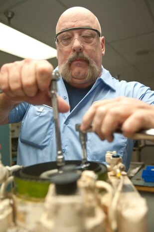 John Delfs, 57th Maintenance Group Propulsion Shop contractor aerospace propulsion mechanic, conducts a clutch and brake disassembly inspection on a Pratt & Whitney F100 engine central gear box Nov. 7, 2013, at Nellis Air Force Base, Nev. The central gear box for an F-15 Eagle is designed to start the motor of the aircraft. The 57th MXG Propulsion Shop is responsible for the maintenance of 185 aircraft engines. (U.S. Air Force photo by Staff Sgt. Christopher Hubenthal)