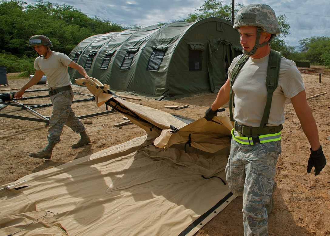 Members from the 647th and 154th Force Support Squadron tear down and prepare a tent for shipment during an Operational Readiness Inspection at Joint Base Pearl Harbor-Hickam, Hawaii, Nov. 7. 2013. This inspection focuses on rapidly getting cargo, equipment and people downrange. (U.S. Air Force photo/Tech. Sgt. Jerome S. Tayborn)