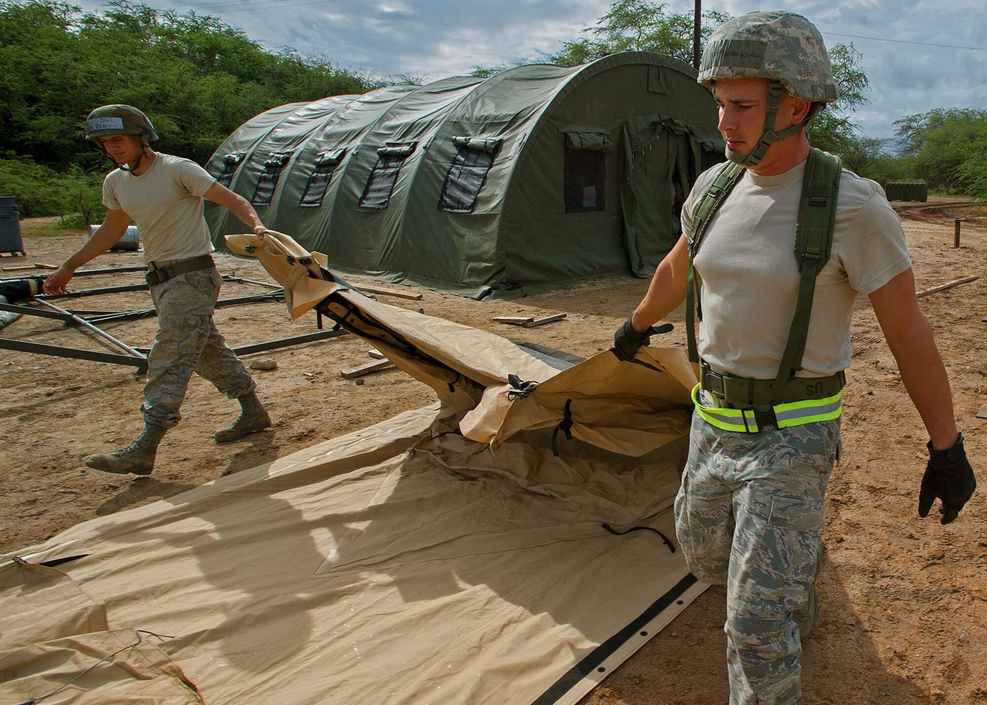 Members from the 647th and 154th Force Support Squadron tear down and prepare a tent for shipment during an Operational Readiness Inspection at Joint Base Pearl Harbor-Hickam, Hawaii, Nov. 7. 2013. This inspection focuses on rapidly getting cargo, equipment and people downrange. (U.S. Air Force photo/Tech. Sgt. Jerome S. Tayborn)