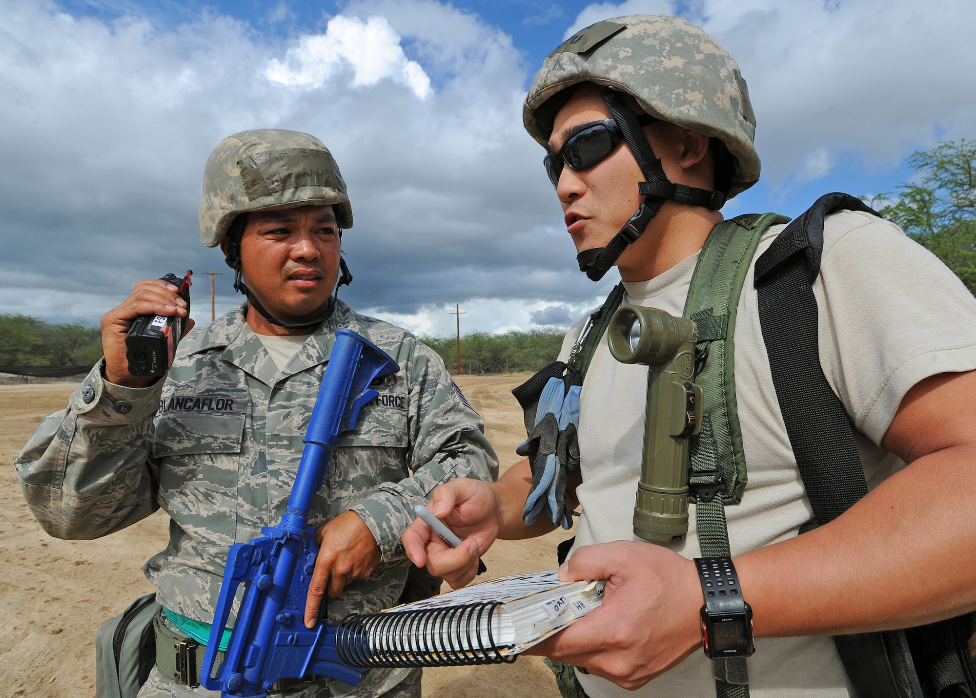 Staff Sgt. Seth Blancuflor, left, and Senior Airman Chu Hyurn, right, from the 154th Force Support Squadron fitness specialists, prepare to radio the location of a discovered unexploded ordinance in a simulated post attack reconnaissance sweep, during an Operational Readiness Inspection at Joint Base Pearl Harbor-Hickam, Hawaii, Nov. 7. 2013. This inspection evaluated Airmen’s ability to respond to survive and operate during various wartime conditions.  (U.S. Air Force photo/Tech. Sgt. Jerome S. Tayborn)
