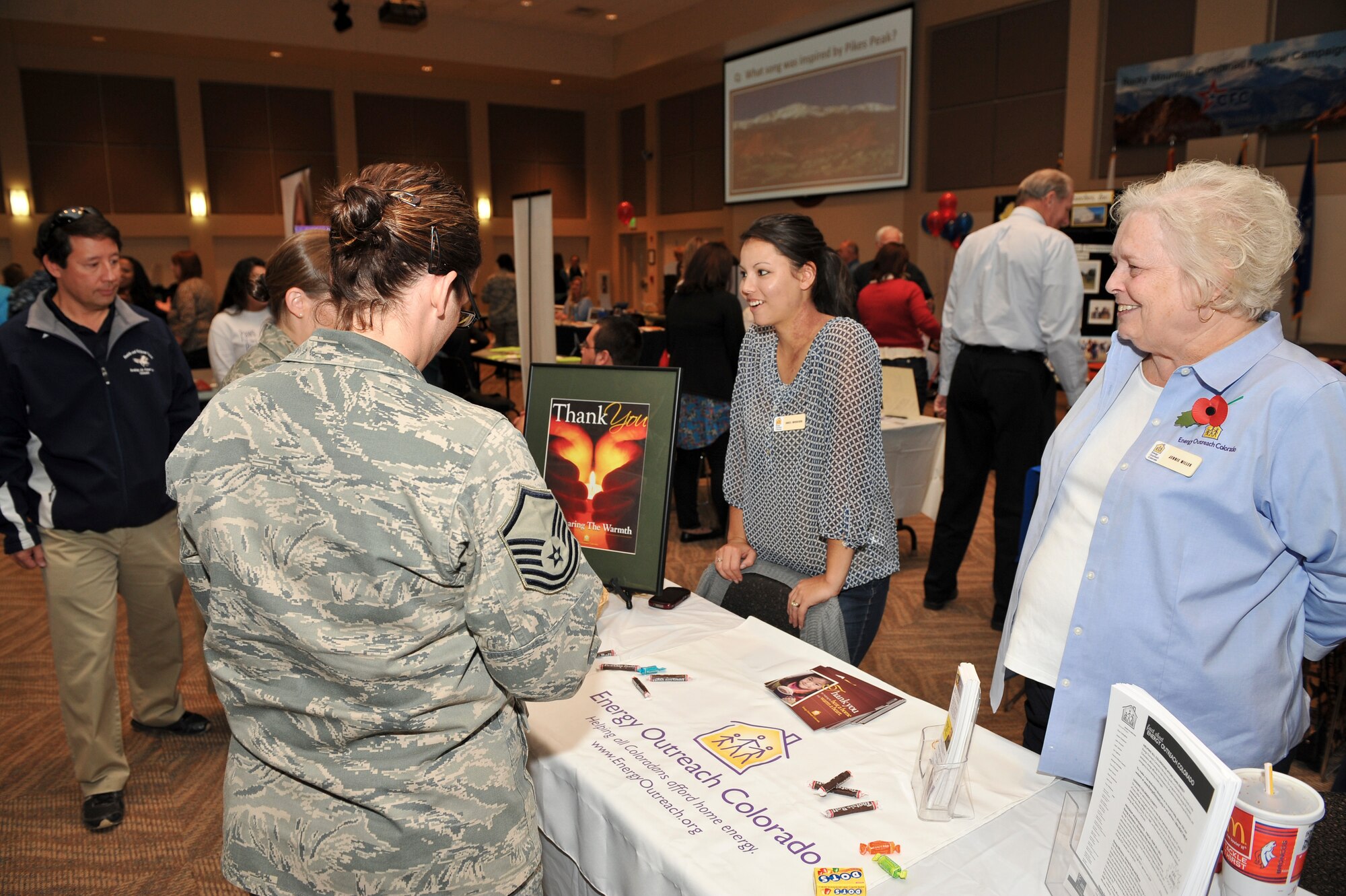 Team Buckley members speak with various local charities about ways to donate during the Combined Federal Campaign Kickoff Nov. 7, 2013, at the Leadership Development Center on Buckley Air Force Base, Colo. The 2013 CFC kicked off with 55 charities being represented and donations by the wing commander and command chief. (U.S. Air Force photo by Senior Airman Phillip Houk/Released)