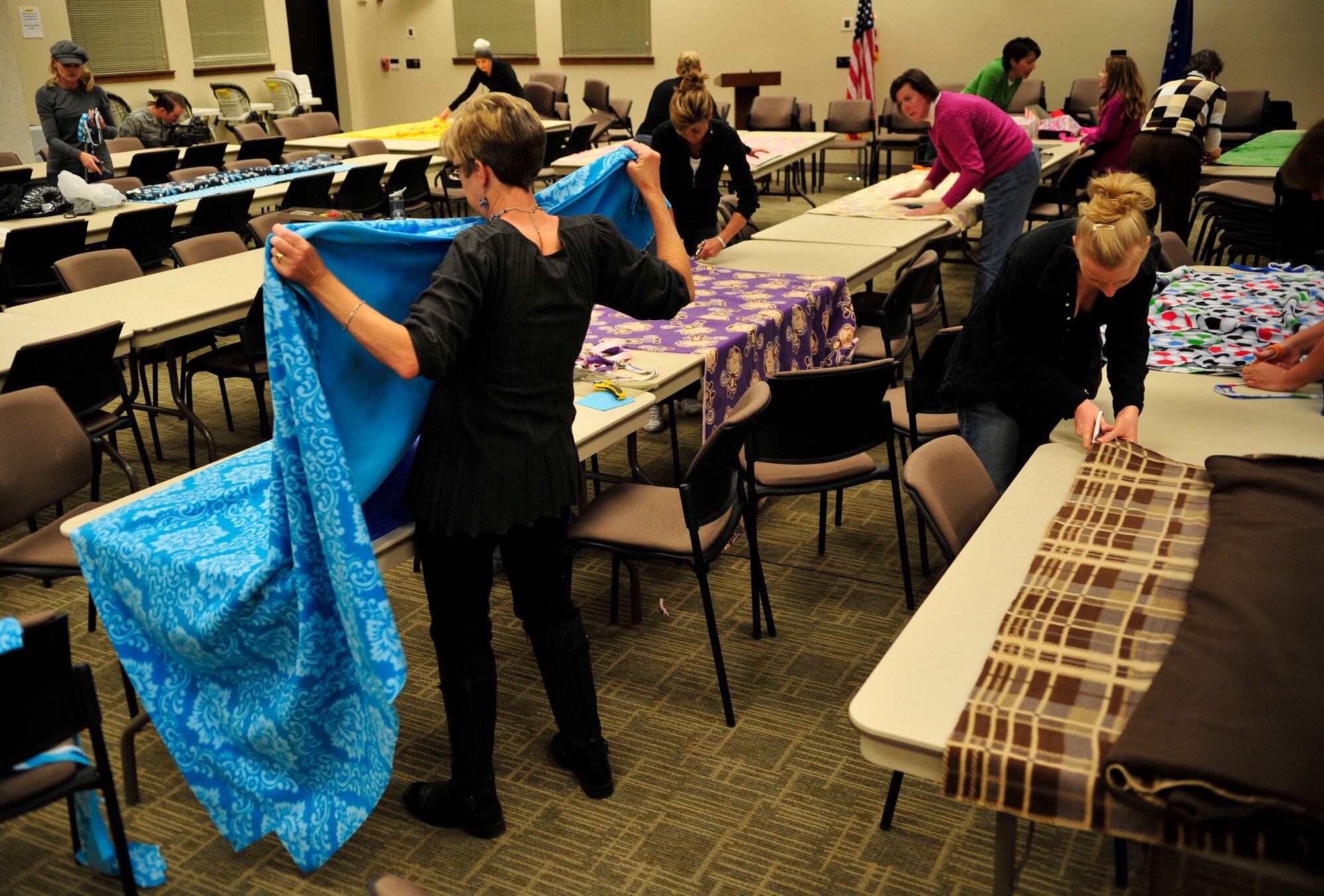 Women gathered with brightly colored fleece to make blankets for donation Nov. 7, 2013, at the chapel on Buckley Air Force Base, Colo. The Women’s Empowerment Group, Buckley Spouses and Buckley Women’s Ministry, along with women from all over the base, joined together to create blankets to donate to the Comitis Crisis Center in Aurora, Colo. (U.S. Air Force Airman 1st Class Samantha Saulsbury/Released)
