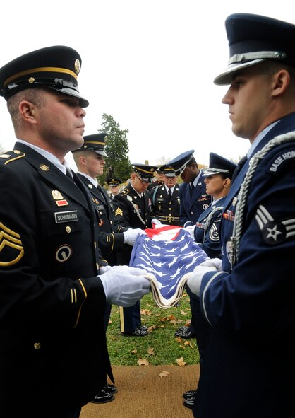 Several Honor Guard members from all over Missouri fold the flag from Ike Skelton’s casket at his funeral in Lexington, Mo., Nov. 4, 2013. Several members of all branches of the military took part of the funeral. (U.S. Air Force photo by Staff Sgt. Alexandra M. Boutte/Released)