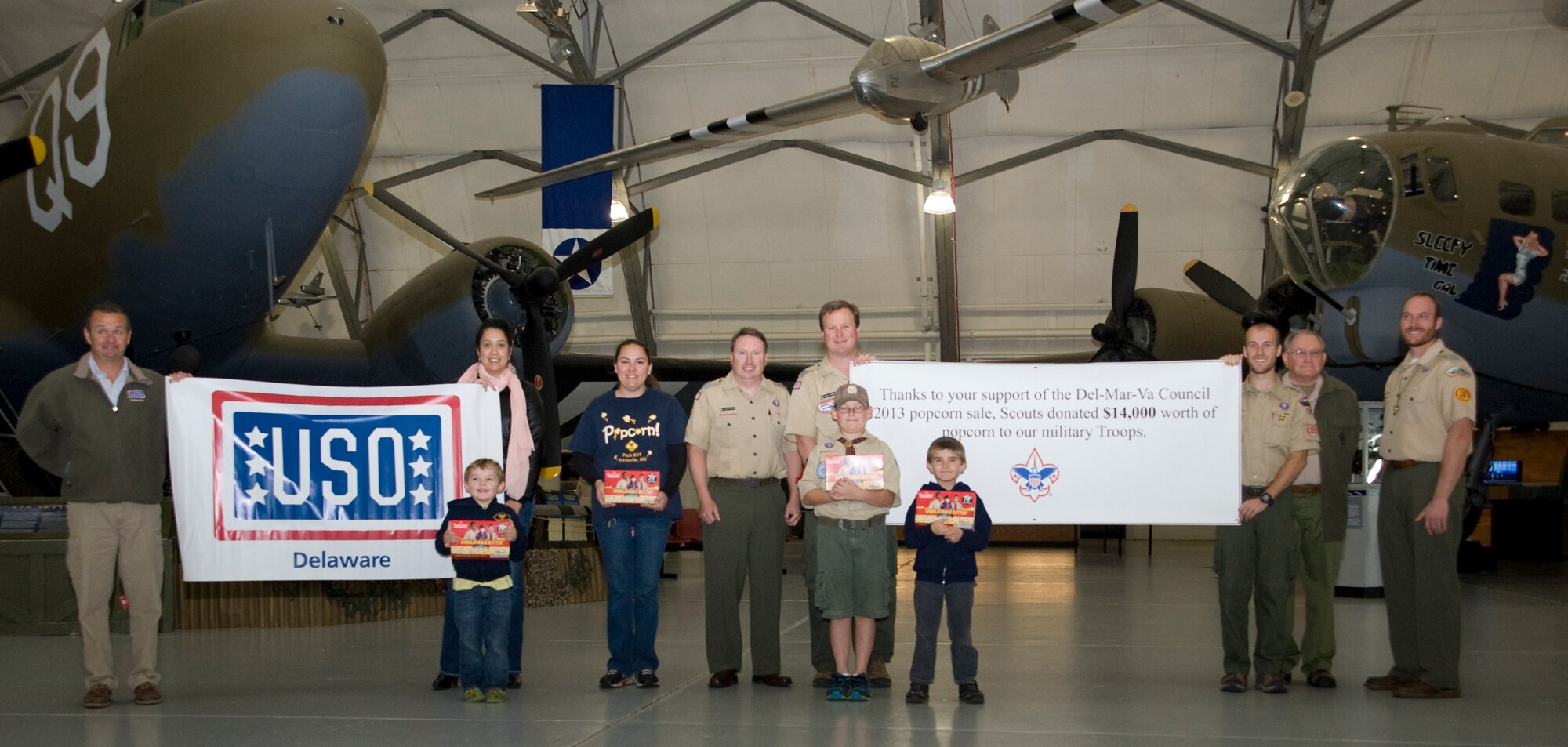 Members of the DelMarVa council of the Boy Scouts of America and the USO of Delaware pose in front of C-47A Skytrain and a B-17G Flying Fortress on Nov. 8, 2013, at the Air Mobility Command Museum on Dover Air Force Base, Del. The Boy Scouts of America donated four pallets of popcorn to the USO to be distributed at Dover. (U.S. Air Force photo/Airman First Class William Johnson)