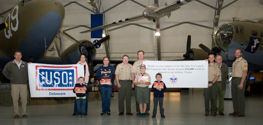 Members of the DelMarVa council of the Boy Scouts of America and the USO of Delaware pose in front of C-47A Skytrain and a B-17G Flying Fortress on Nov. 8, 2013, at the Air Mobility Command Museum on Dover Air Force Base, Del. The Boy Scouts of America donated four pallets of popcorn to the USO to be distributed at Dover. (U.S. Air Force photo/Airman First Class William Johnson)