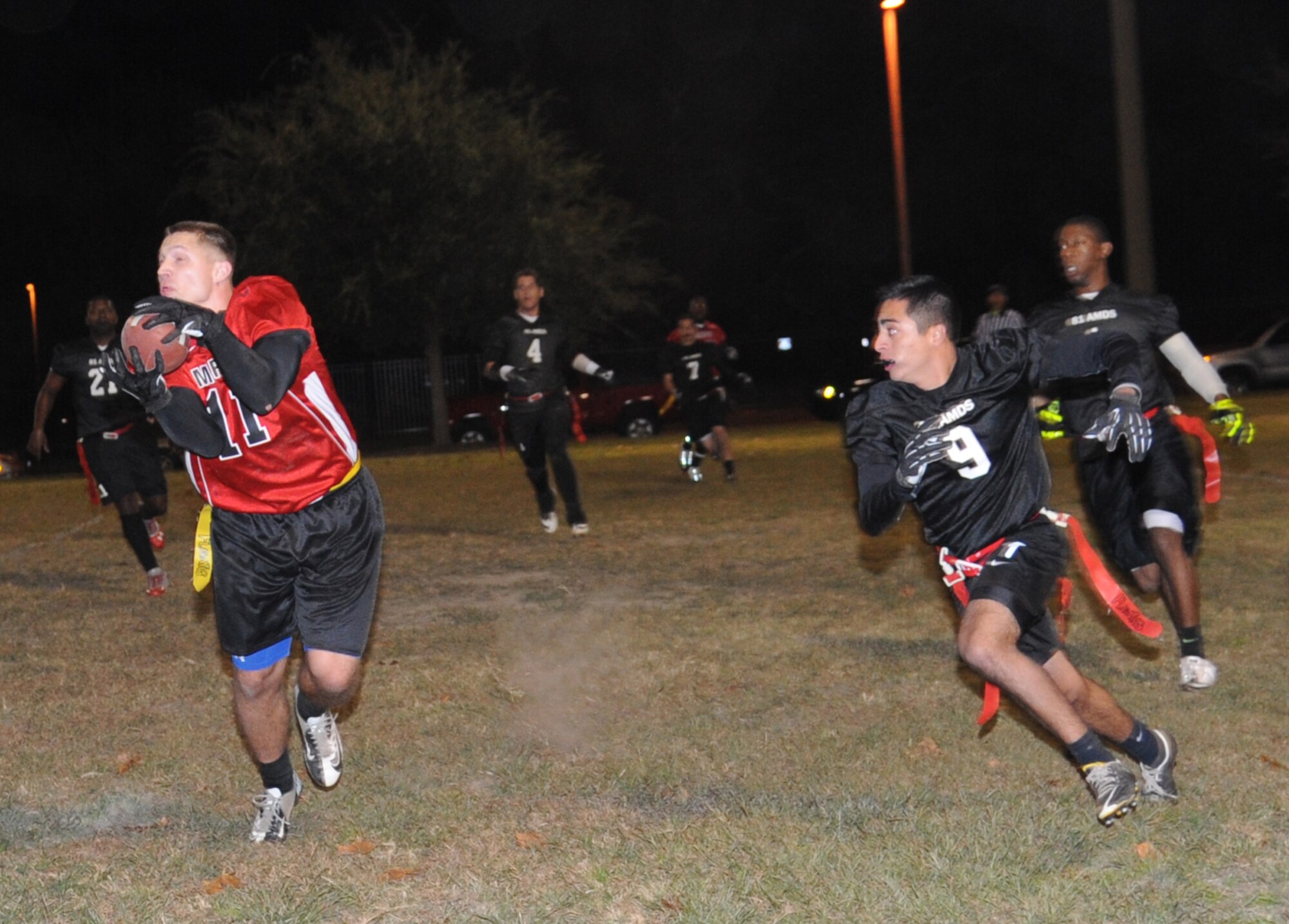 Andrew Batzel, Keesler Marine Detachment, catches the ball in the end zone for a touchdown as Samuel Valles, 81st Aerospace Medicine Squadron, closes in on him during the intramural flag football championship game Nov. 7, 2013, at Keesler Air Force Base, Miss.  The Marines defeated 81st AMDS, 26-14.  (U.S. Air Force photo by Kemberly Groue)