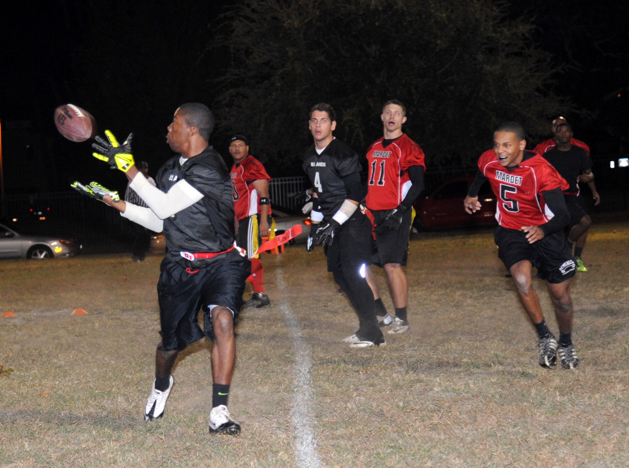 David Gibson, 81st Aerospace Medicine Squadron, turns for the catch as he approaches for a touchdown as Jahel Carter, #5, Keesler Marine Detachment, closes in during the intramural flag football championship game Nov. 7, 2013, at Keesler Air Force Base, Miss.  The Marines defeated 81st AMDS, 26-14.  (U.S. Air Force photo by Kemberly Groue)