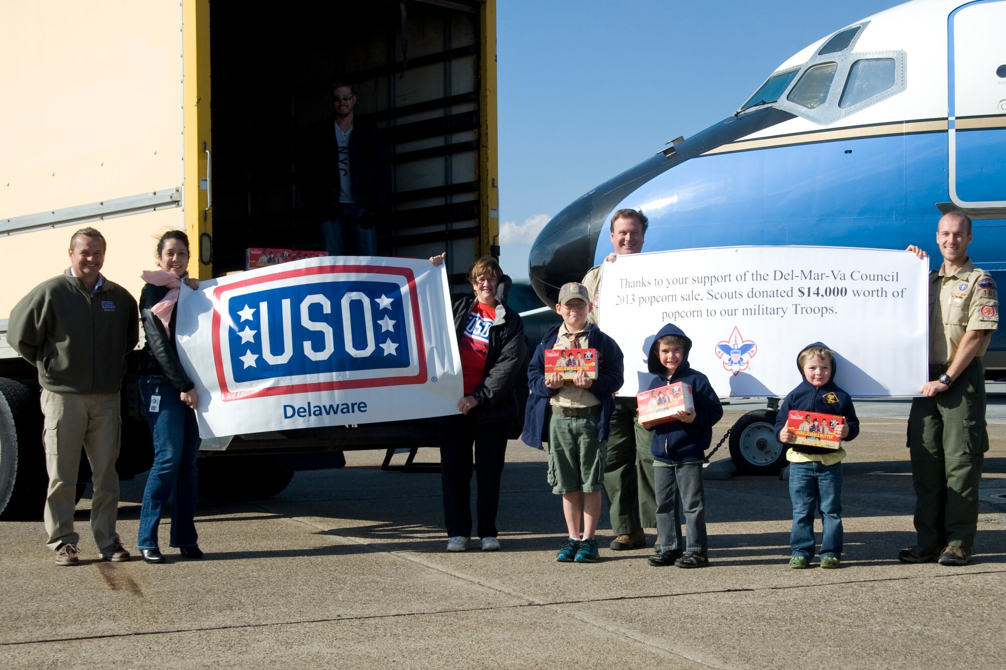 Members of the DelMarVa council of the Boy Scouts of America donate four pallets of popcorn to the USO of Delaware on Nov. 8, 2013, at the Air Mobility Command Museum on Dover Air Force Base, Del. The popcorn was received from the Military Donation Program through the Boy Scouts of America popcorn sale. (U.S. Air Force photo/Airman 1st Class William Johnson)