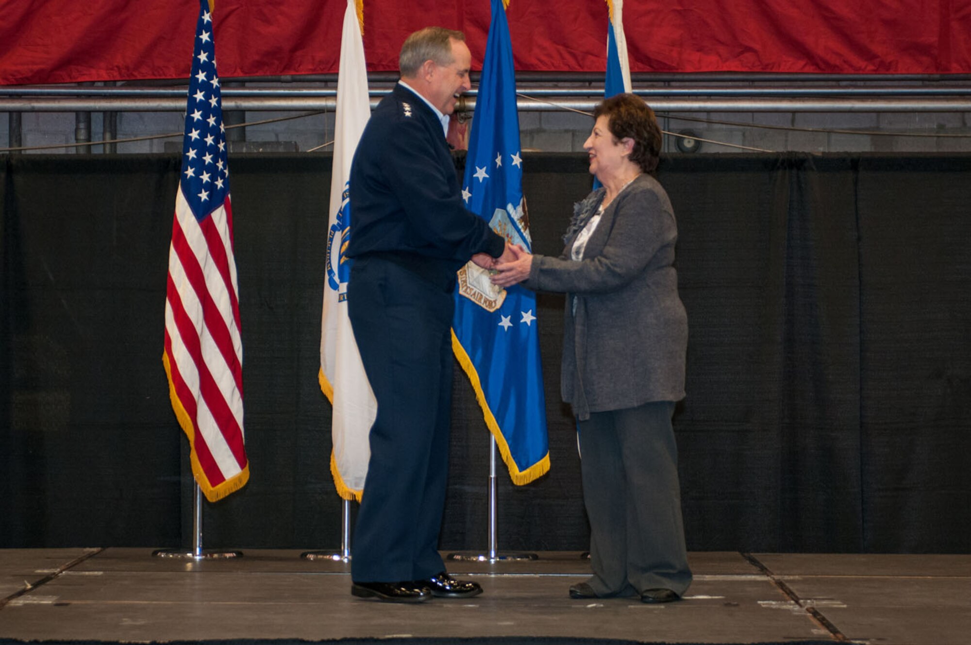 HANSCOM AIR FORCE BASE, Mass. - Air Force Chief of Staff Gen. Mark A. Welsh III recognizes Maria Bandouveres, executive assistant to the program executive officer for C3I and networks, during his all-call at the Aero Club hangar here Nov. 7. Bandouveres was recognized for her work spanning a career where she has supported nearly 20 commanders and PEOs. (U.S. Air Force photo by Rick Berry)