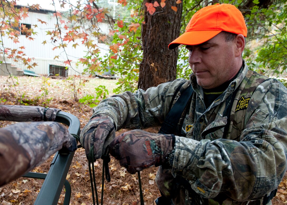 Hunter Eric Brazzale sets up his high-seat before hunting at Fort Eustis, Va., Nov. 5, 2013.  Hunters on Joint Base Langley-Eustis are required to use a harness and other safety equipment when hunting in a high-seat or tree stand.  (U.S. Air Force photo by Shaun Eagan/Released)  