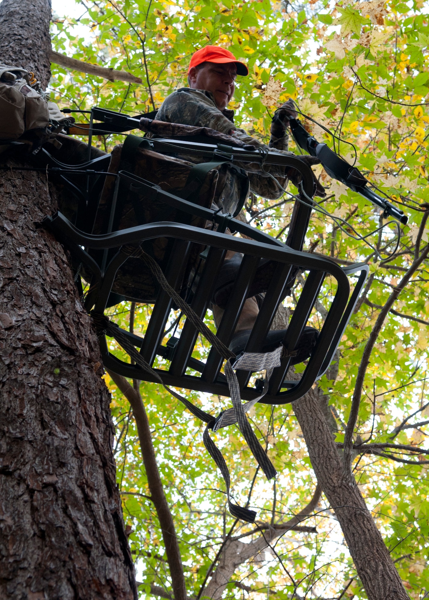 Hunter Eric Brazzale pulls his muzzle-loading rifle up to his tree stand at Fort Eustis, Va., Nov. 5, 2013.  Joint Base Langley-Eustis allows hunters to use a tree stand or high-seat for hunting on base. (U.S. Air Force photo by Shaun Eagan/Released)  