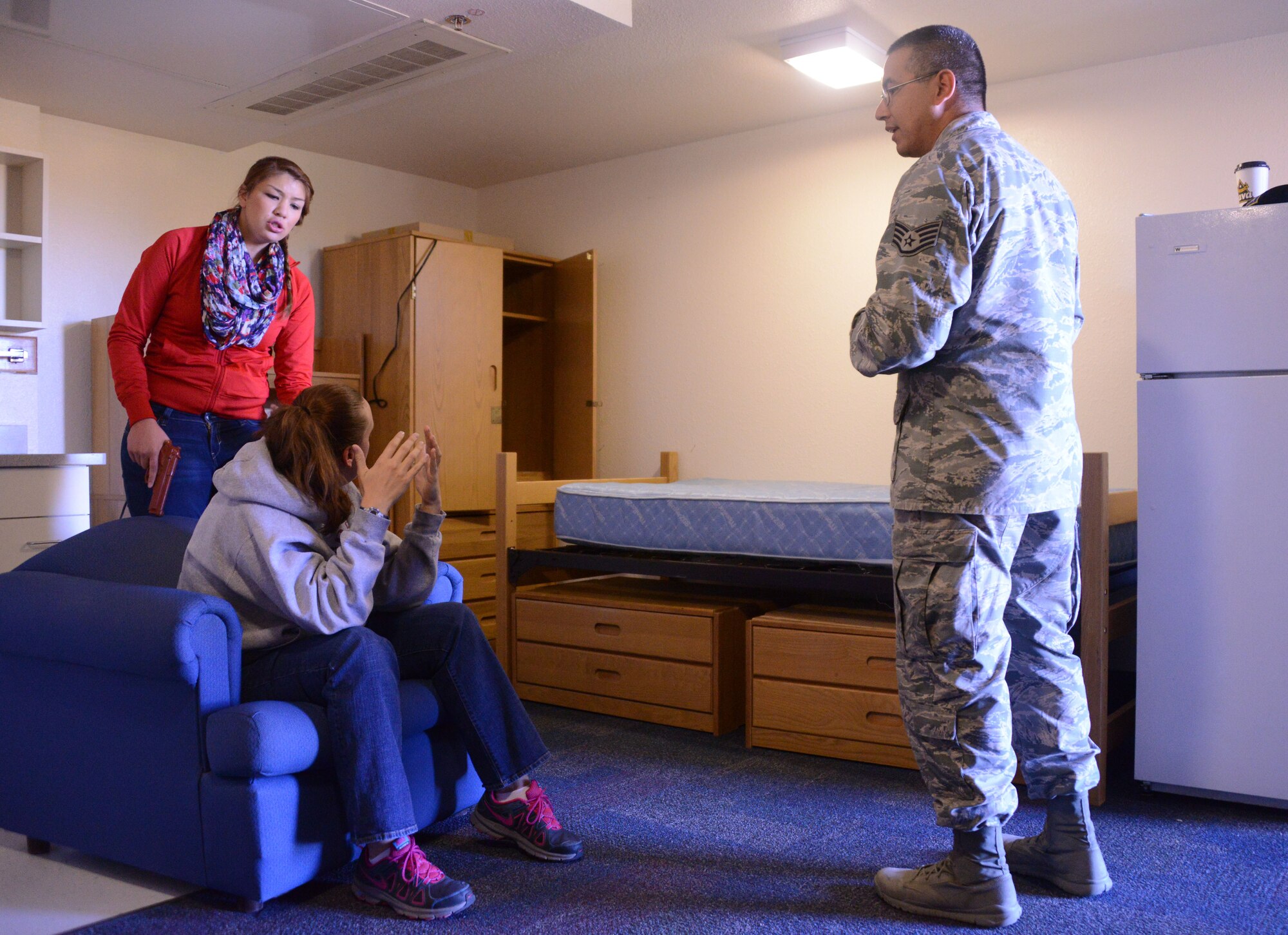 Civilian volunteers roleplay a volatile domestic dispute, as Staff Sgt. Steven Saenz, 377th Security Forces Squadron, tries to diffuse the situation using skills learned in a crisis negotiation course.  Members of the 377th SFS spent a week learning verbal skills and techniques to use to resolve high risk incidents peacefully. (Photo by Todd Berenger)