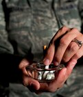 Tech. Sgt. Tina Meehan, 5th Munitions Squadron munitions controller, demonstrates putting out a cigarette, Nov. 7, 2013. Meehan, who quit smoking 14 months ago, will be participating in the Great American Smokeout event at Minot Air Force Base, N.D., Nov. 21. (U.S. Air Force photo/Senior Airman Brittany Y. Auld)