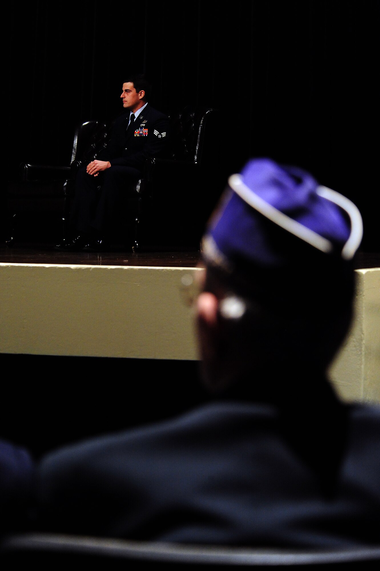 Carlyle Waters, Military Order of the Purple Heart Chapter 657 member, watches as Senior Airman Justin Beasley, 4th Civil Engineer Squadron explosive ordnance disposal technician, is honored during a Purple Heart ceremony at Seymour Johnson Air Force Base, N.C., Nov. 8, 2013.  Three members of the chapter were present to welcome Beasley to the group.  Beasley was presented the Purple Heart for wounds received in action.  (U.S. Air Force photo by Airman 1st Class Brittain Crolley)