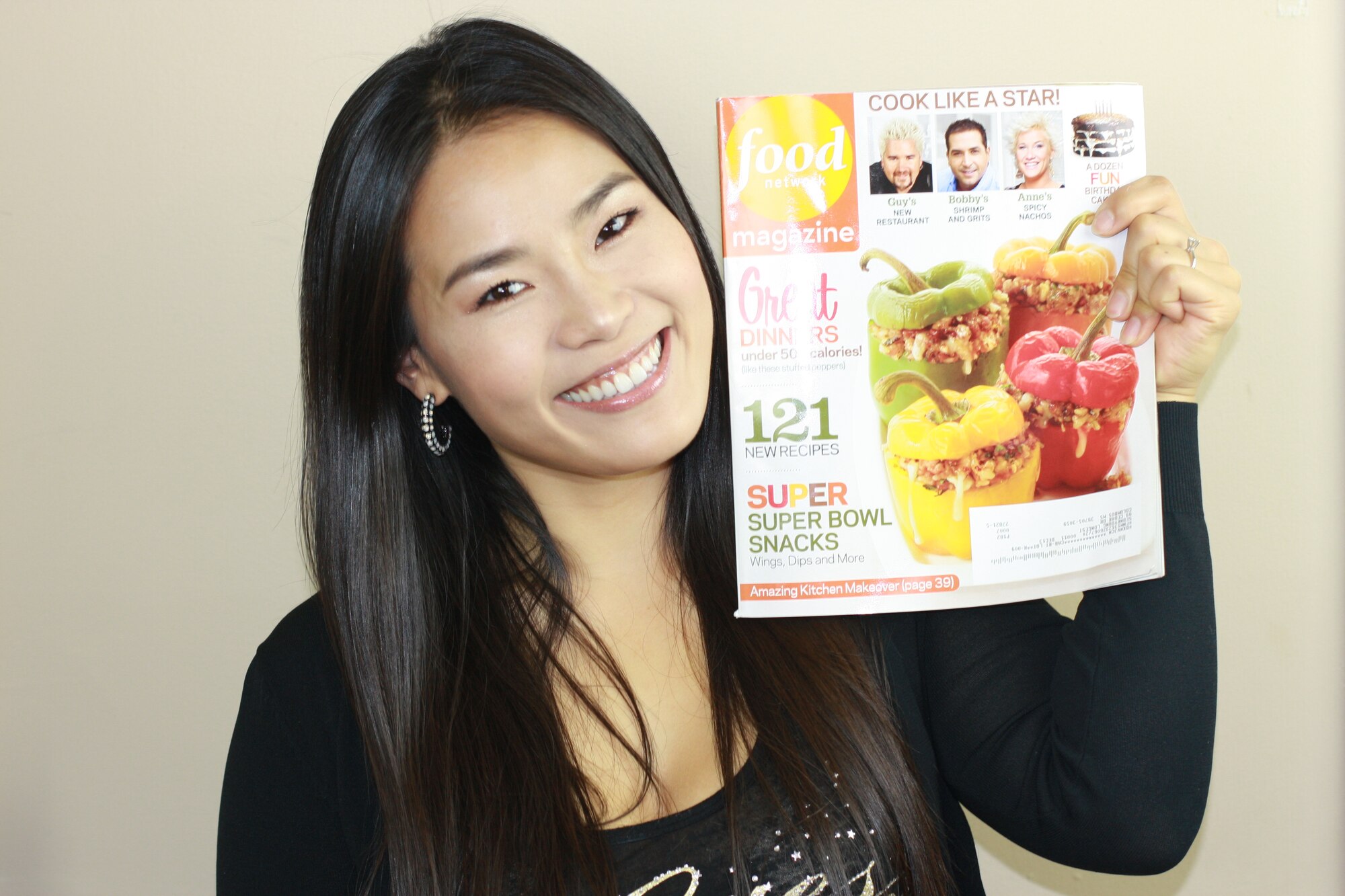 Seonkyoung Longest, spouse of Master Sgt. Jacob Longest, 14th Medical Operations Squadron, holds up a copy of Food Network Magazine. Mrs. Longest moved to Columbus Air Force Base in 2009 and used the Food Network to not only improve her English, but to ignite her passion of cooking. (Courtesy Photo)