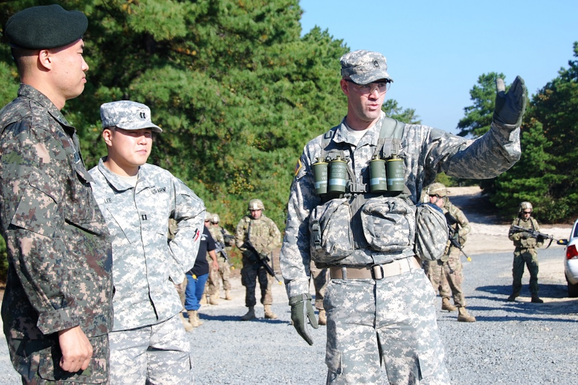 Sgt. 1st Class Denis Cronin, 174th Infantry Brigade observer controller/trainer, patrol leader and counter-IED instructor, briefs Maj. Ji Hwan Park, Third Republic of Korea Army mobilization training officer, on counter-improvised explosive device collective field training Oct. 2-4, 2013, during his visit to Joint Base McGuire-Dix-Lakehurst, N.J. Cronin also briefed Park on the dismounted-patrol mobilization training given to deploying service members. (U.S. Army courtesy photo/Released)