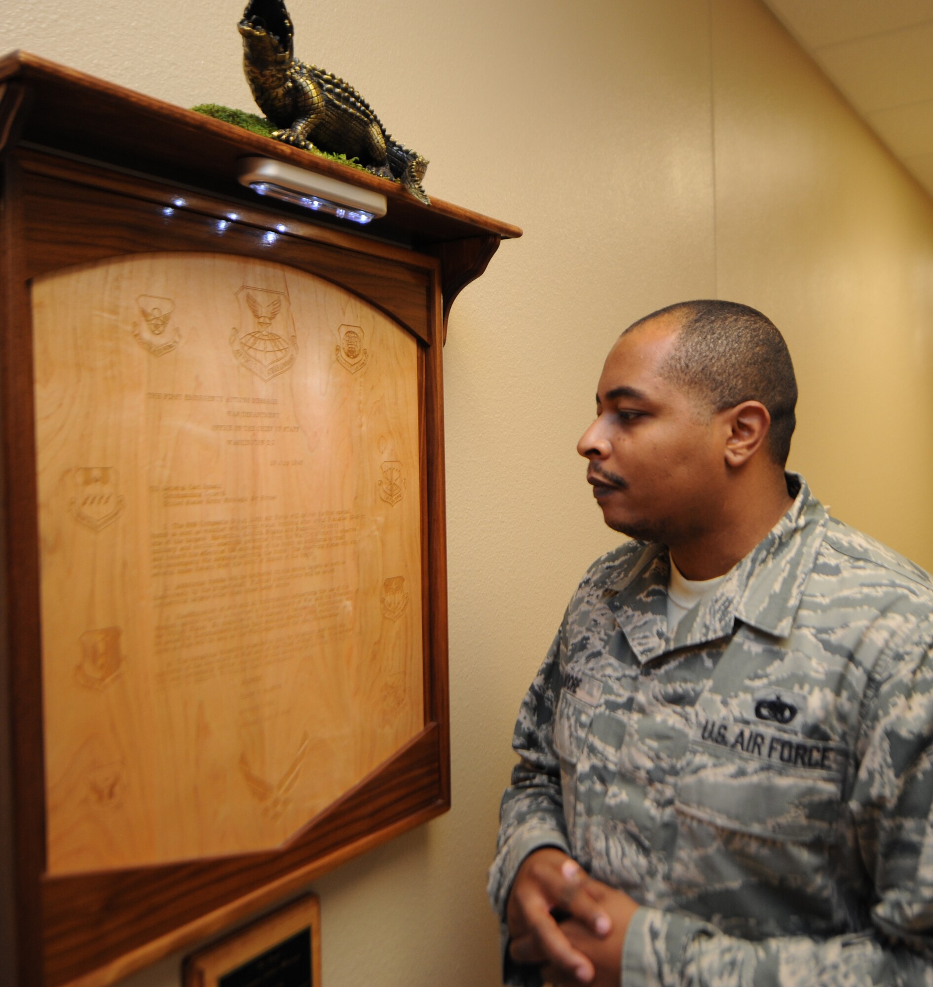 Tech. Sgt. Daniel Moore, 334th Training Squadron student, reads a plaque presented by the Air Force Global Strike Command with the first emergency action message which was unveiled during a 334th Training Squadron command post apprentice course re-dedication ceremony Nov. 7, 2013, at Cody Hall, Keesler Air Force Base, Miss.  The course and simulator equipment was moved from Bryan Hall to Cody Hall after room modifications were made by the Trainer Maintenance and Trainer Development Center.  (U.S. Air Force photo by Kemberly Groue)