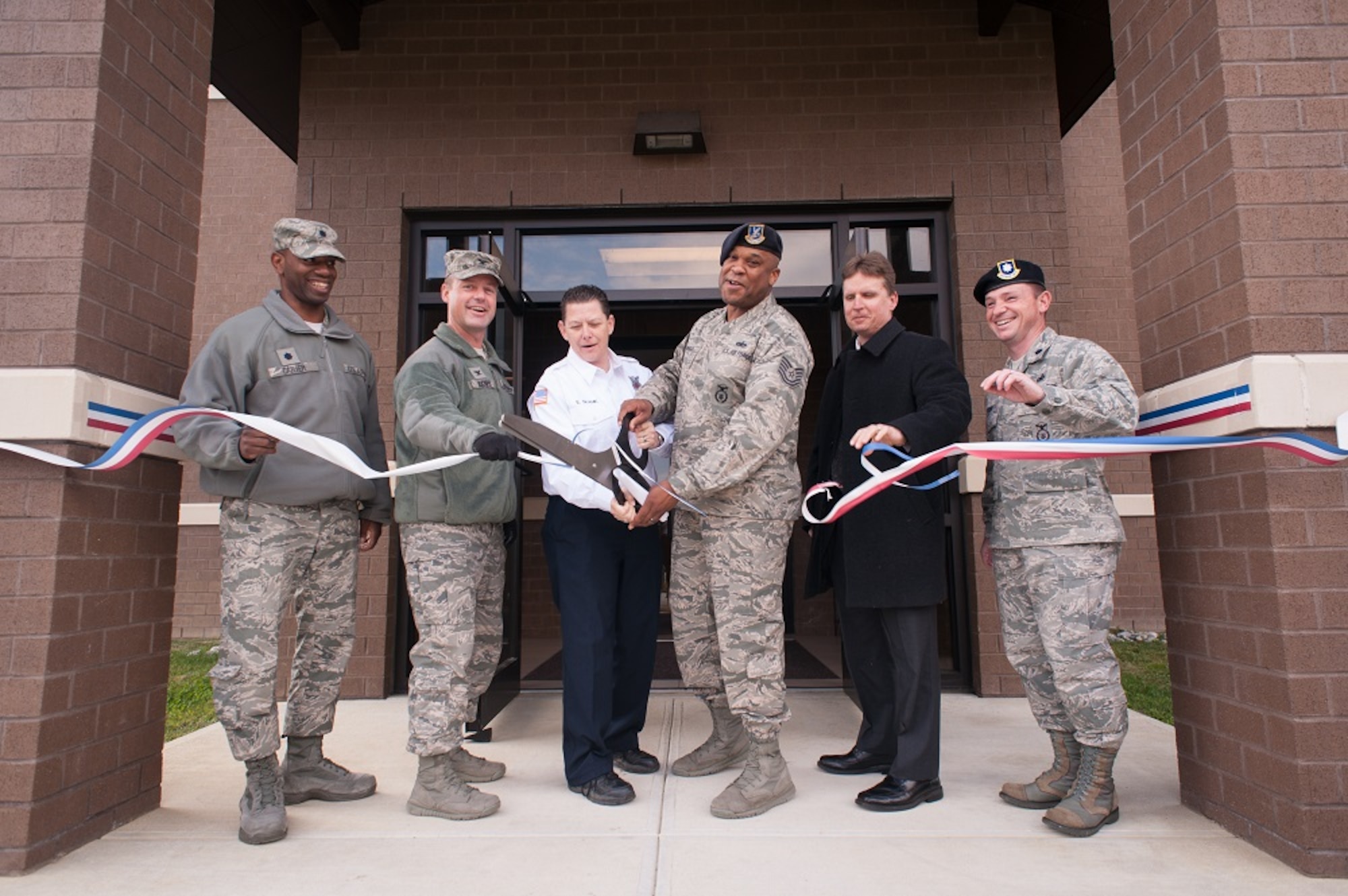 From left, Lt. Col. Ivory Carter, 87th Mission Support Group deputy commander; Col. James C. Hodges, 87th Air Base Wing, Joint Base McGuire-Dix-Lakehurst commander; Elaina Shank, 87th Civil Engineer Squadron Fire Department ECC supervisor; Tech. Sgt. Duwayne McCoy, 87th Security Forces Squadron noncommissioned officer in charge; Kevin Kaysing, 87th MSG deputy commander, and Lt. Col. Patrick Steen, 87th SFS commander, take part in the ribbon cutting ceremony at the 87th SFS Headquarters Oct. 24, 2013, at JB MDL, N.J. The new facility will consolidate all security and fire-alarm capabilities into one centralized monitoring location for JB MDL. (U.S. Air Force photo by Russ Meseroll/Released)