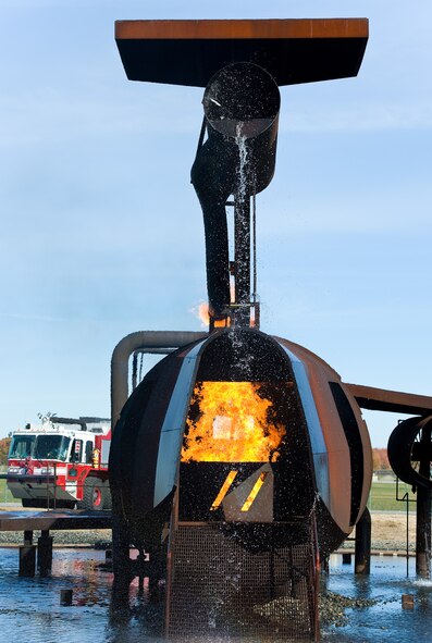 Flames engulf the cargo compartment of the aircraft fire trainer Nov. 4, 2013, at the fire training area on Dover Air Force Base, Del. Temperatures inside the trainer can reach up to 1,500 degrees Fahrenheit. (U.S. Air Force photo/Roland Balik)
