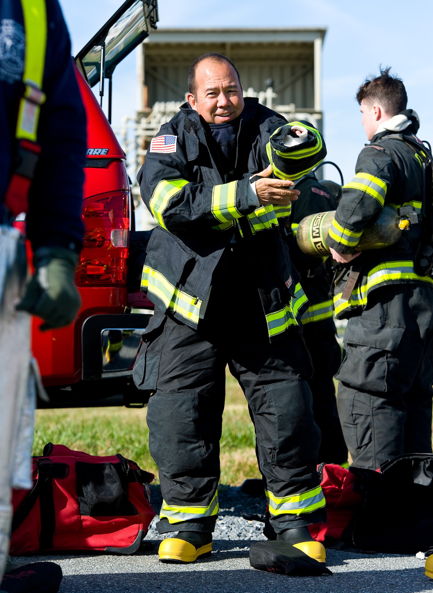 Col. Thomas Reppart, 436th Mission Support Group commander, puts on structural firefighting gear Nov. 4, 2013, at the fire training facility on Dover Air Force Base, Del. Reppart took part in a joint training exercise for 436th and 512th Civil Engineer Squadron Fire Departments. (U.S. Air Force photo/Roland Balik)